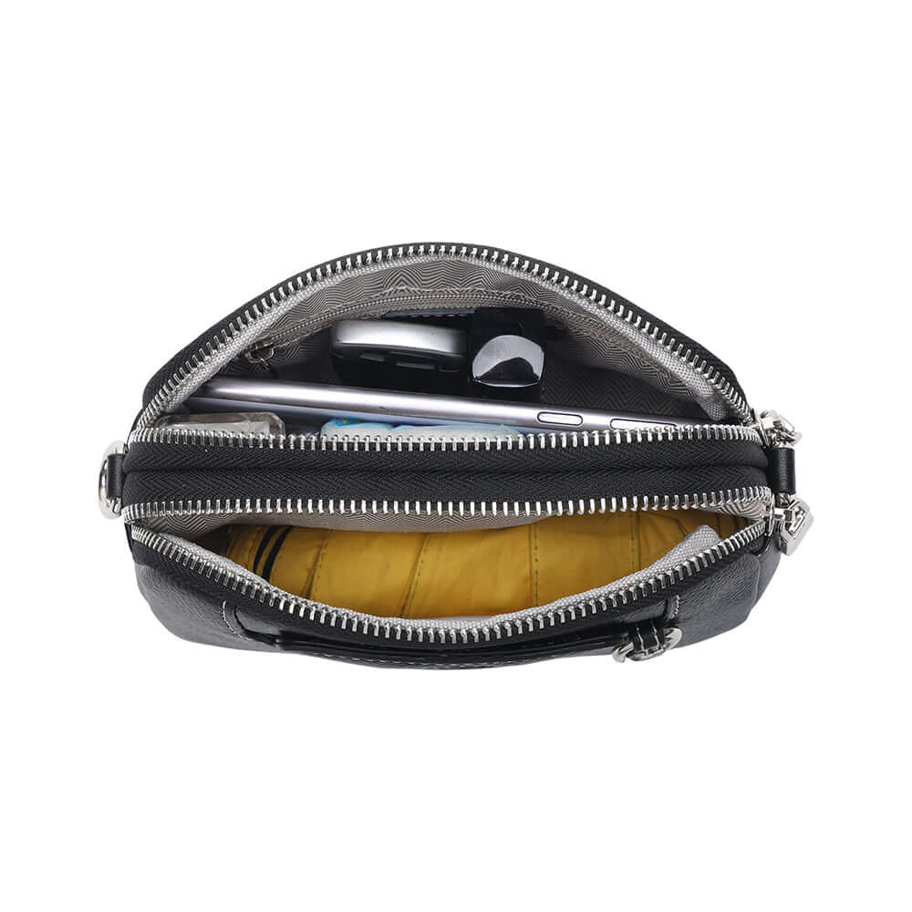 Interior view of mini leather crossbody bag featuring pocket and lining.