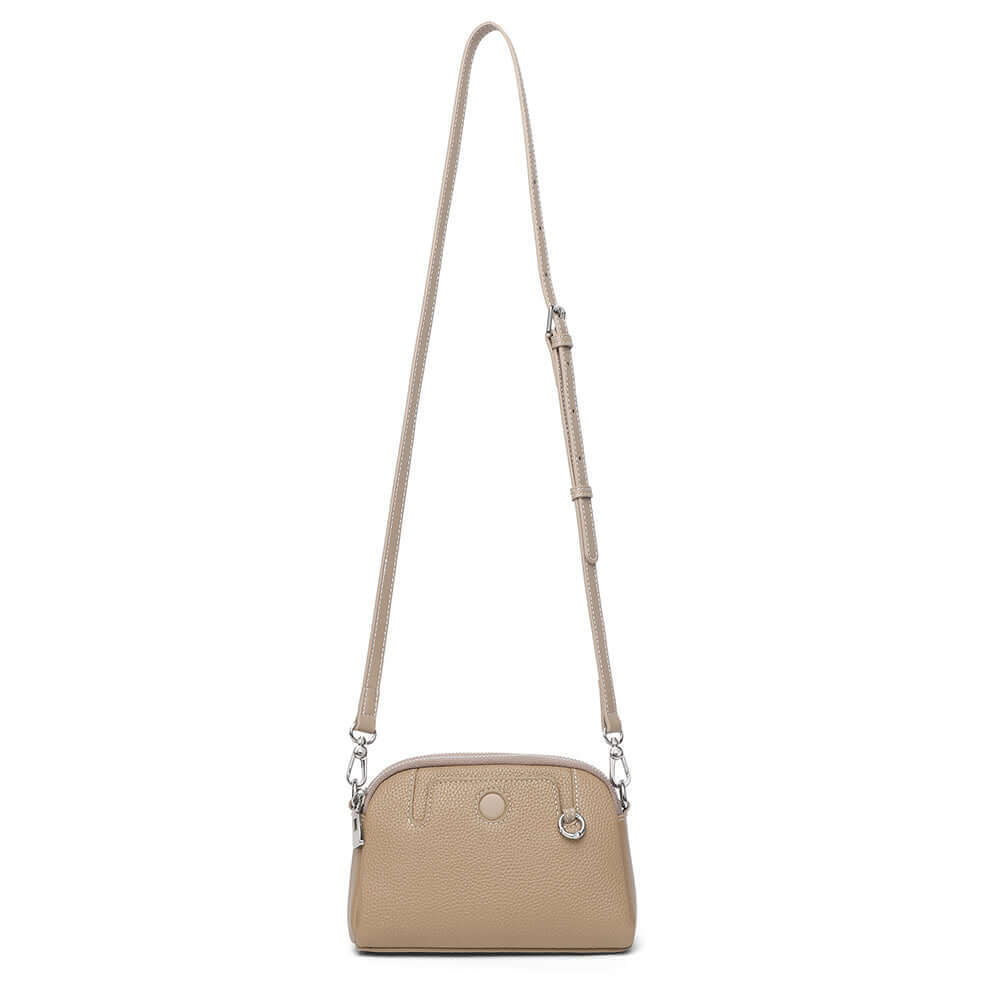Mini leather crossbody bag worn over shoulder for chic casual styling.