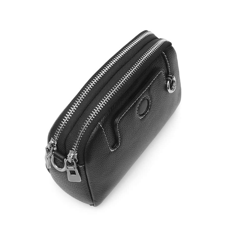 Mini leather crossbody bag with double zipper design and metal hardware.