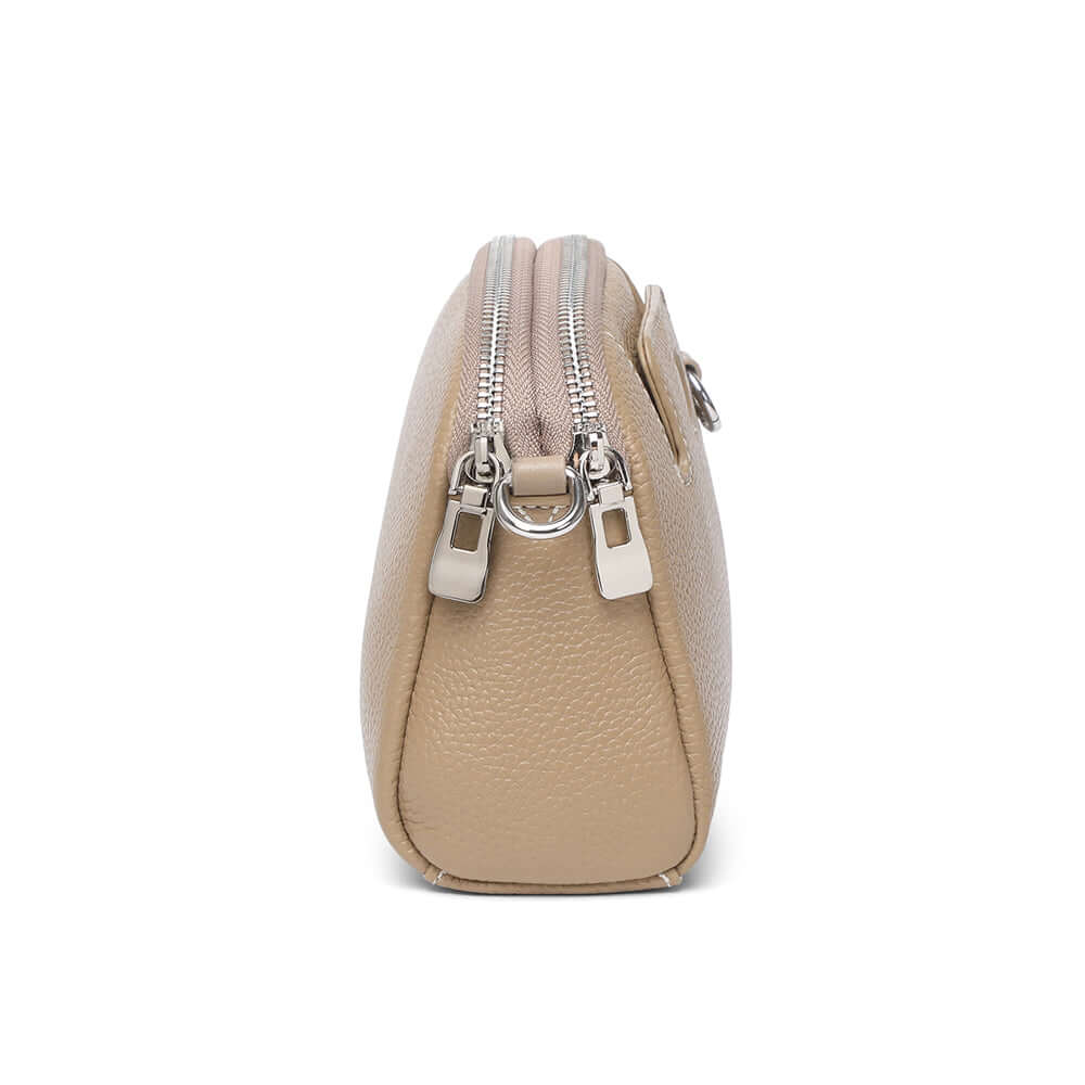 Mini leather crossbody bag showing two separate zipper sections for organization.