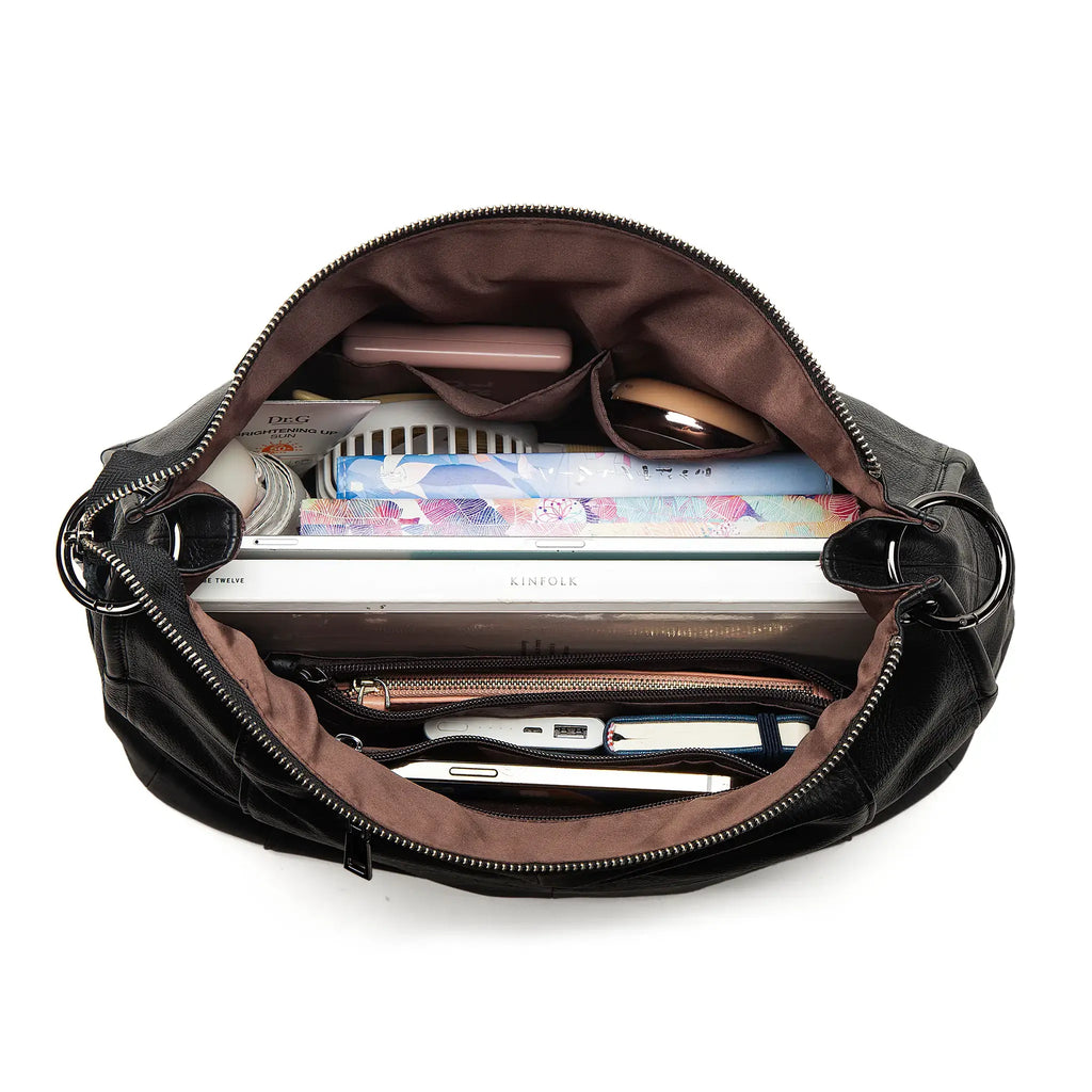 Open black handbag with various items