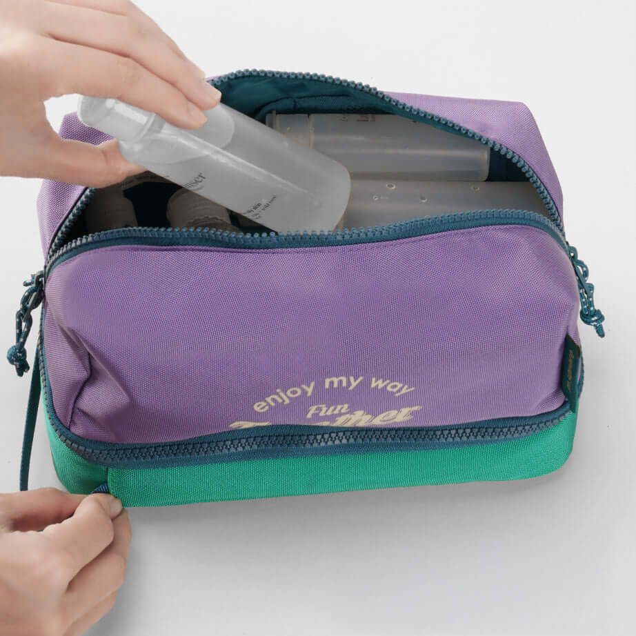 Travel toiletry bag with organized essentials inside compartments.