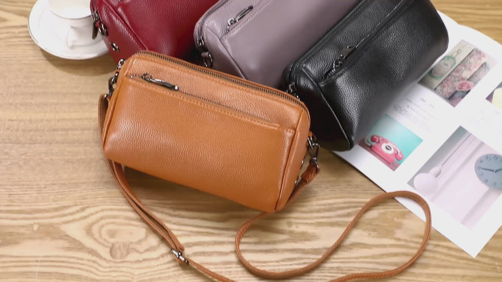 Leather crossbody bag with multiple zippers and pockets for easy organization.