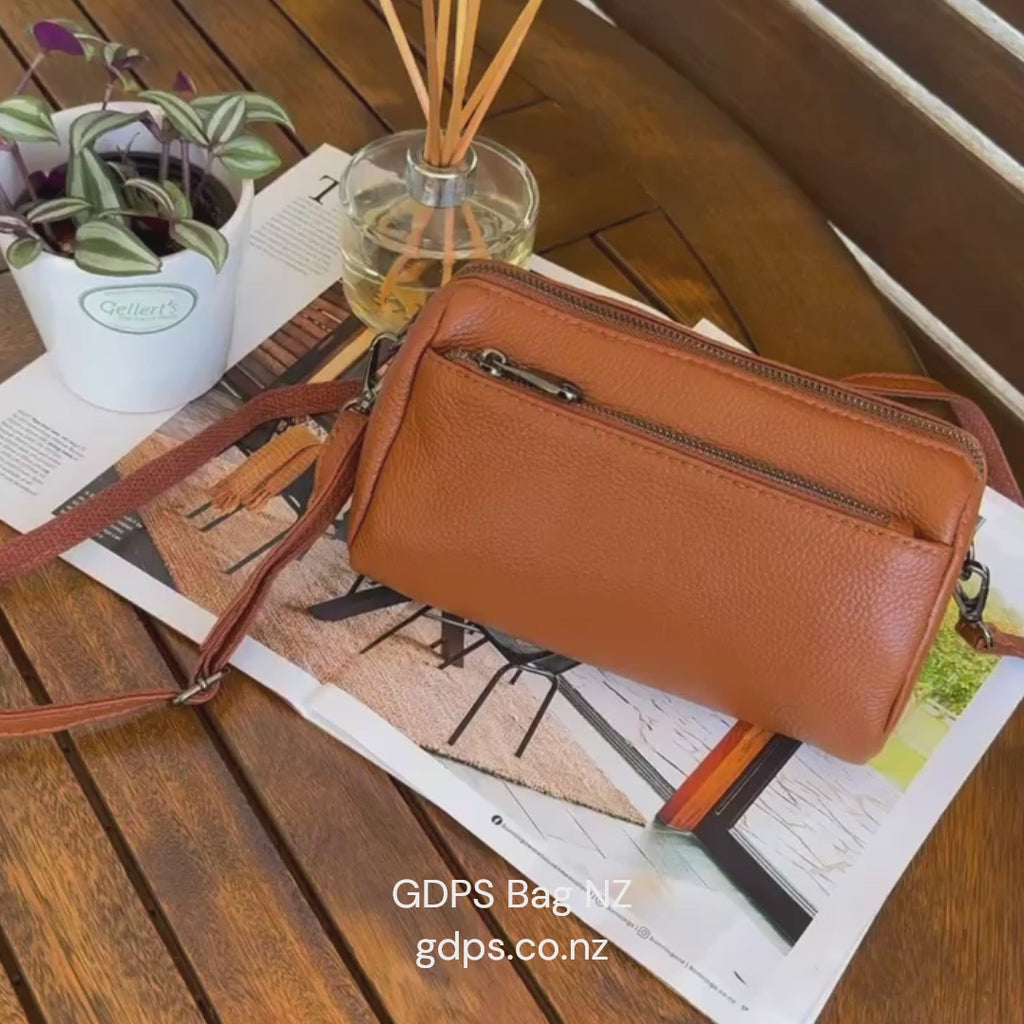 Women's minimalist leather crossbody bag with supple texture and elegant design.