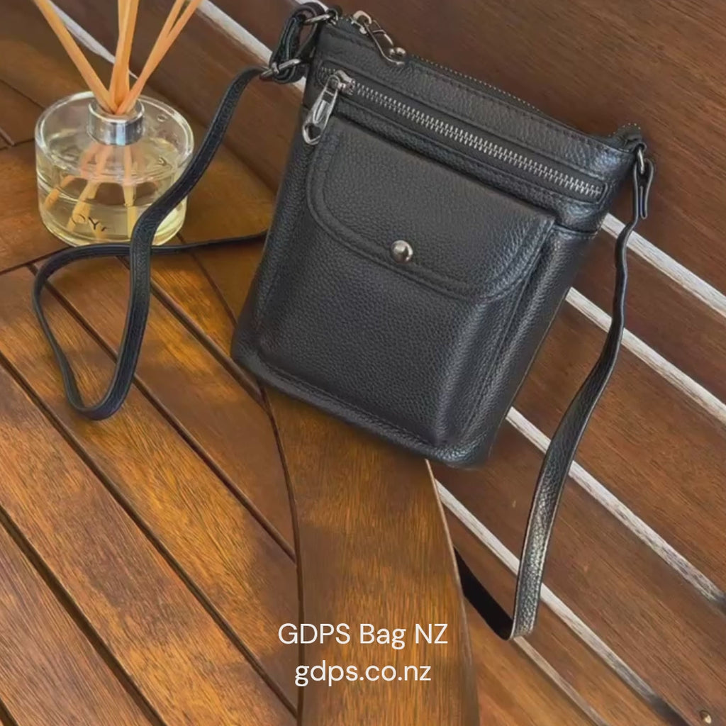 Black leather small crossbody bag for daily use, featuring sleek design and functional pockets.