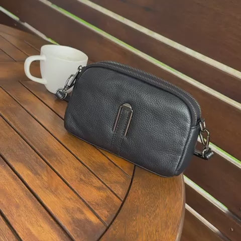 Small black leather crossbody bag for women, perfect for everyday use and easy organization.