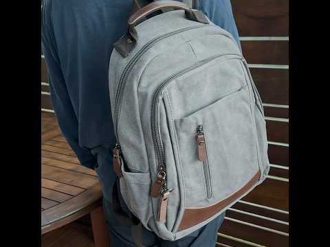 Canvas laptop backpack with PU leather accents, suitable for 15.6-inch laptops.