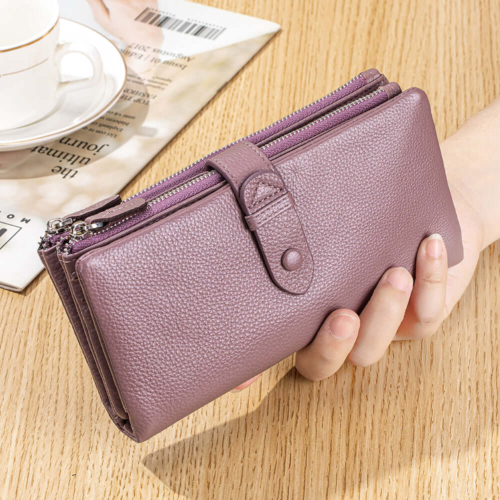 Purple wallet held by a hand