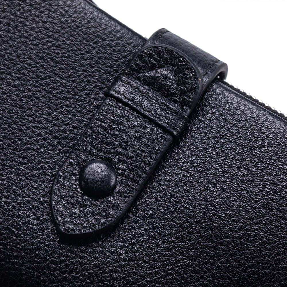 Snap button closure detail on leather wallet