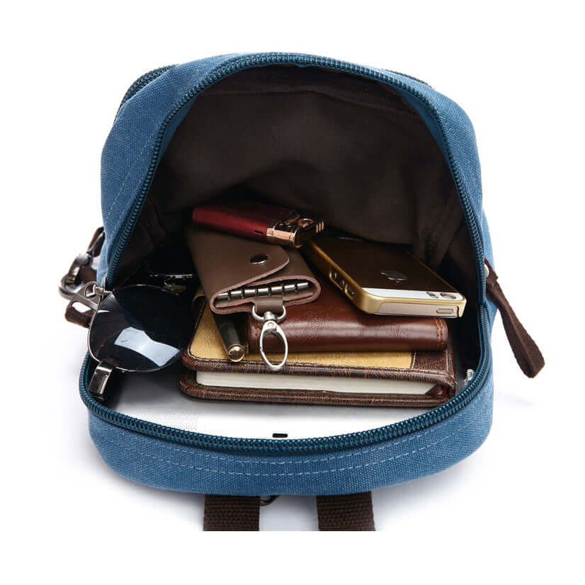 Detail view of front snap pocket on small canvas backpack