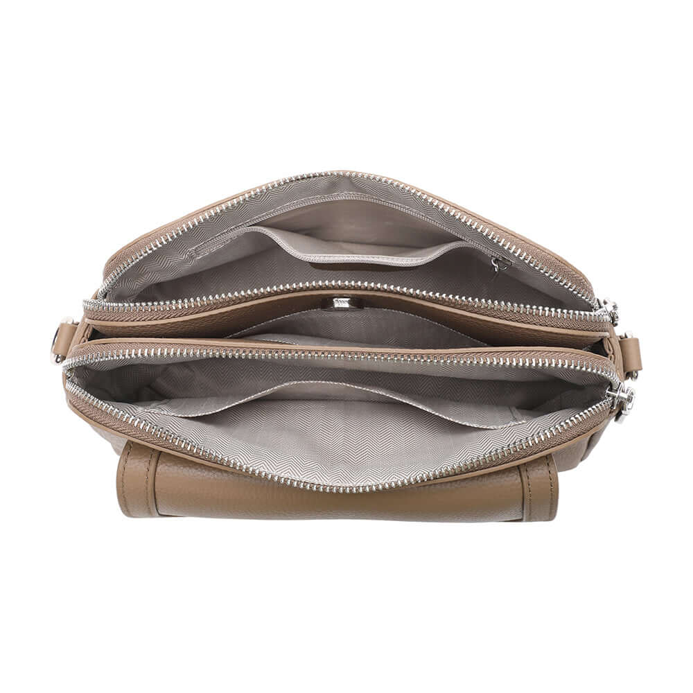 Interior layout of taupe leather crossbody with multiple compartments.