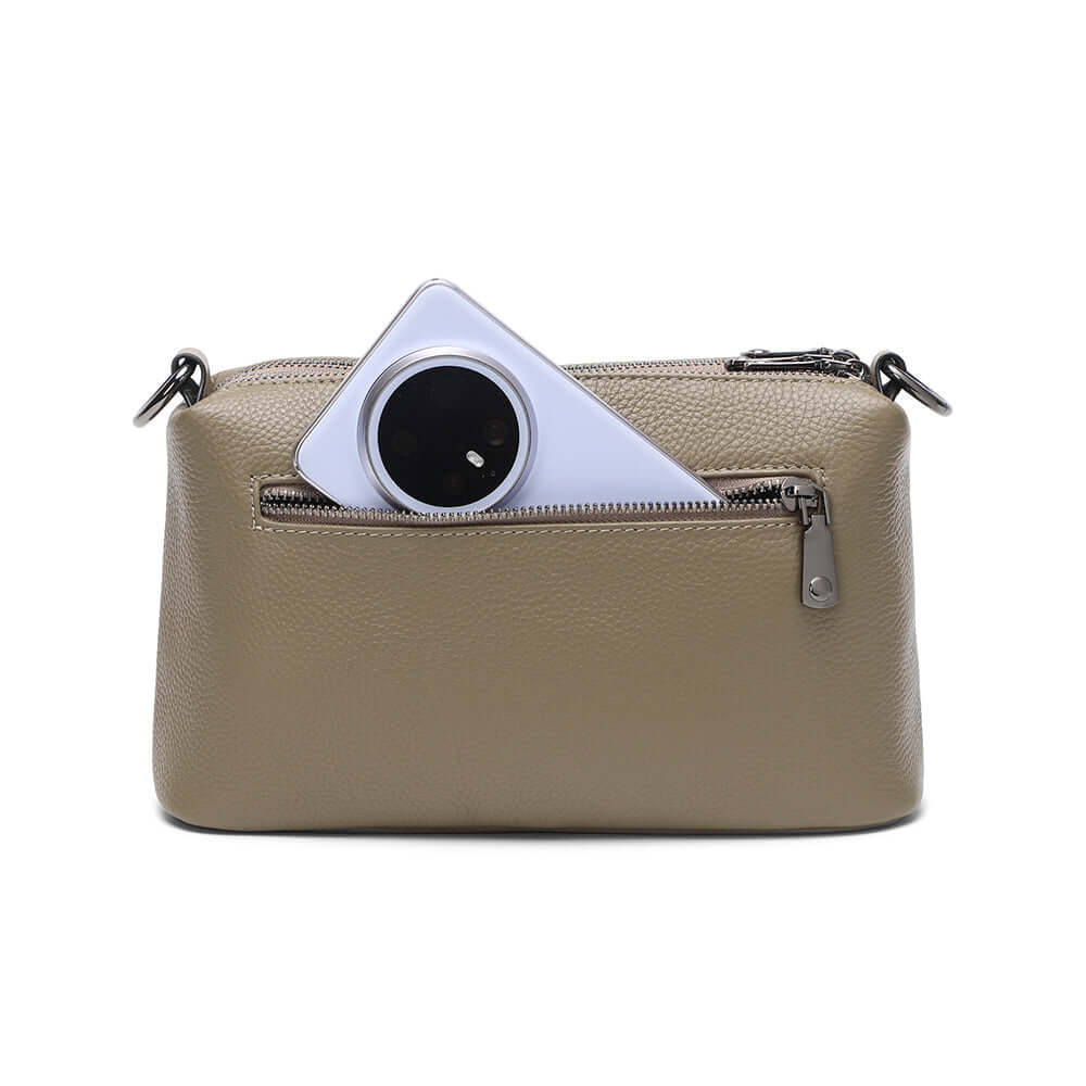 Taupe leather crossbody bag with a zippered back compartment.