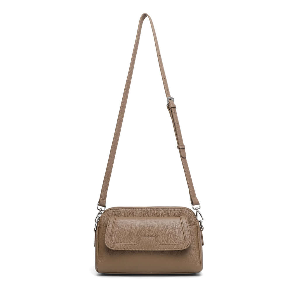 Women’s taupe leather crossbody bag with long shoulder strap.