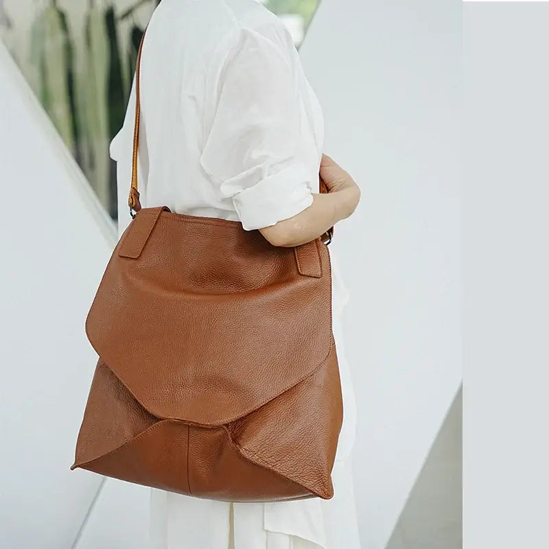 Leather tote bag worn as a crossbody