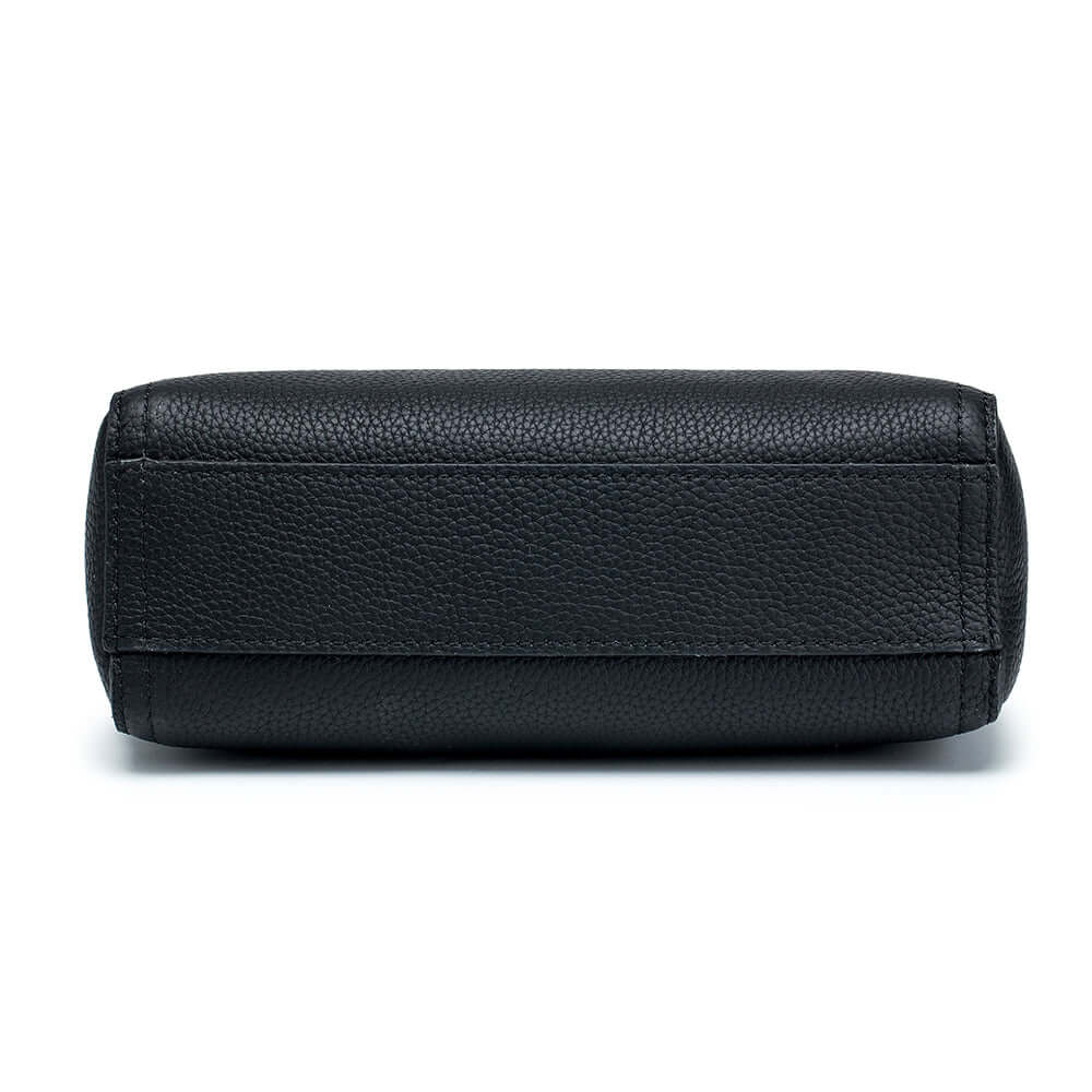 Close-up of pebbled leather texture – premium genuine leather handbag in black.
