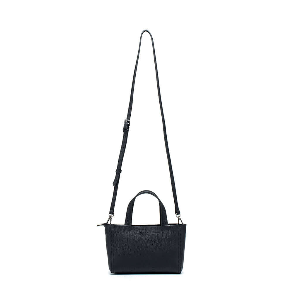 Versatile leather mini handbag in black – front view with smooth texture and minimal design.