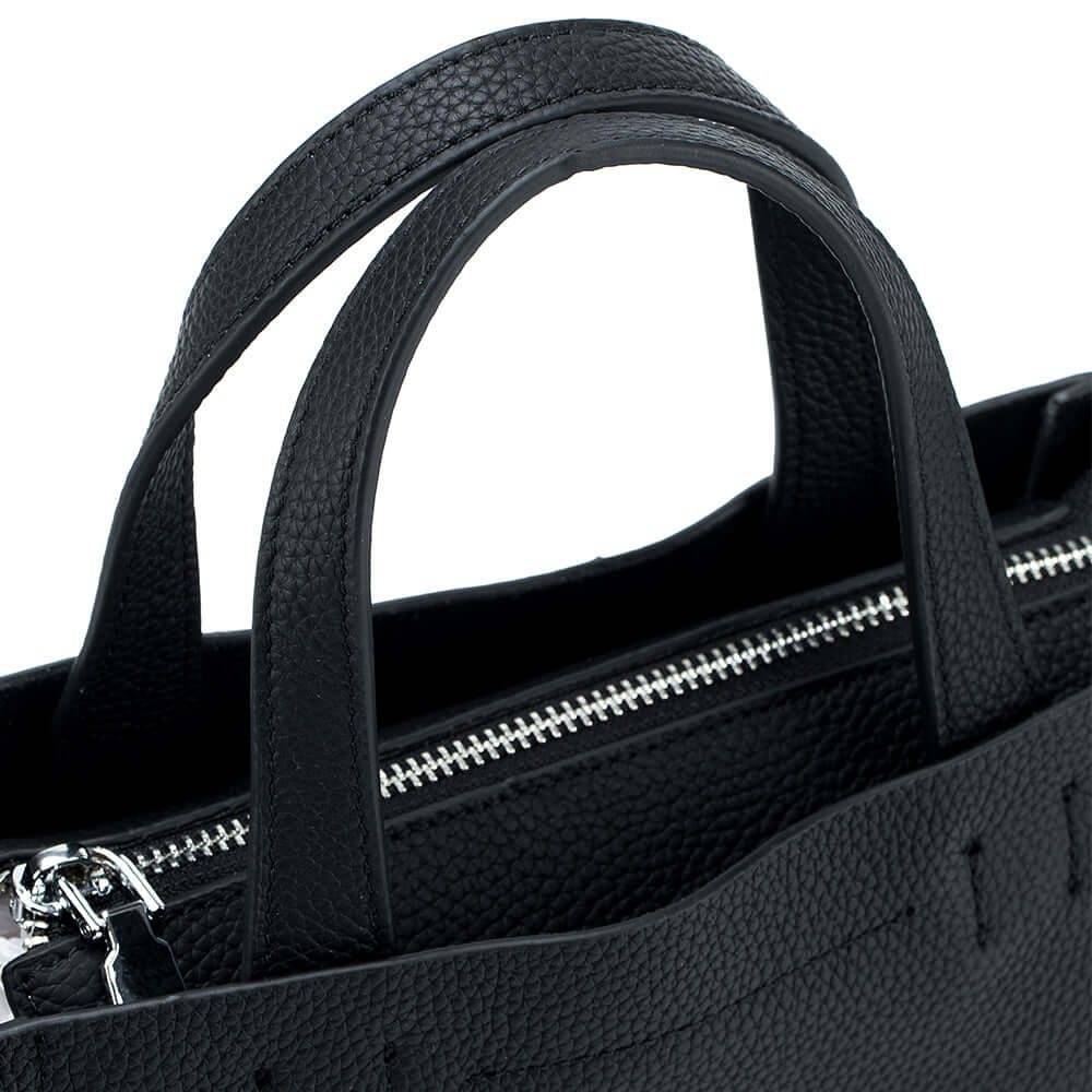 Close-up of leather handles showing fine craftsmanship and grain texture.
