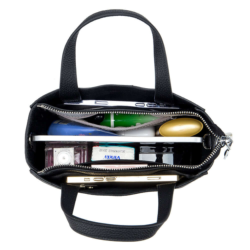 Inside view of leather mini handbag – spacious compartment with zip pocket.