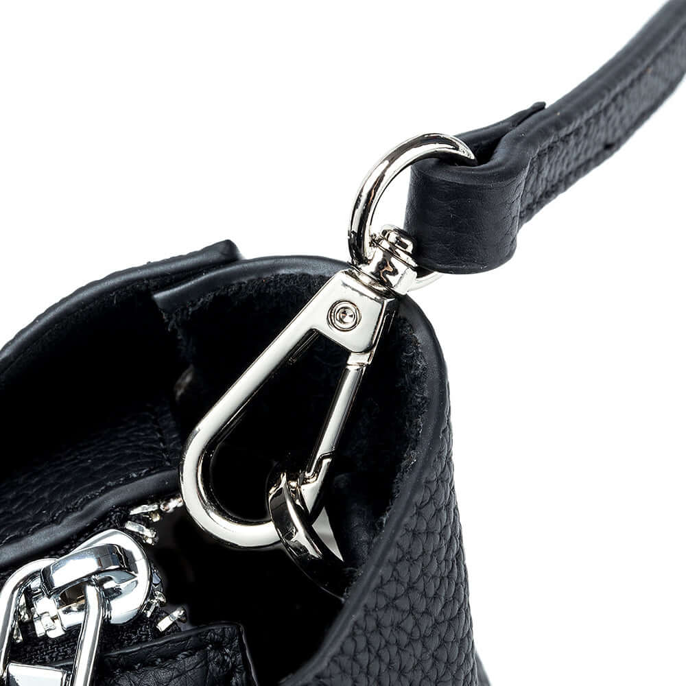 Stitching and edge finish detail of the versatile black leather mini handbag.