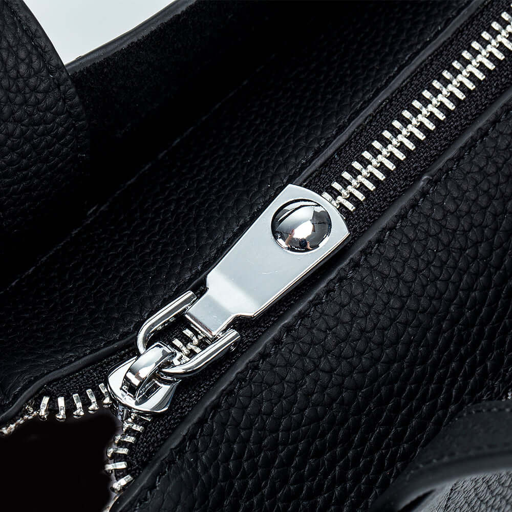 Zipper and metal hardware detail of black leather mini handbag – elegant and durable.