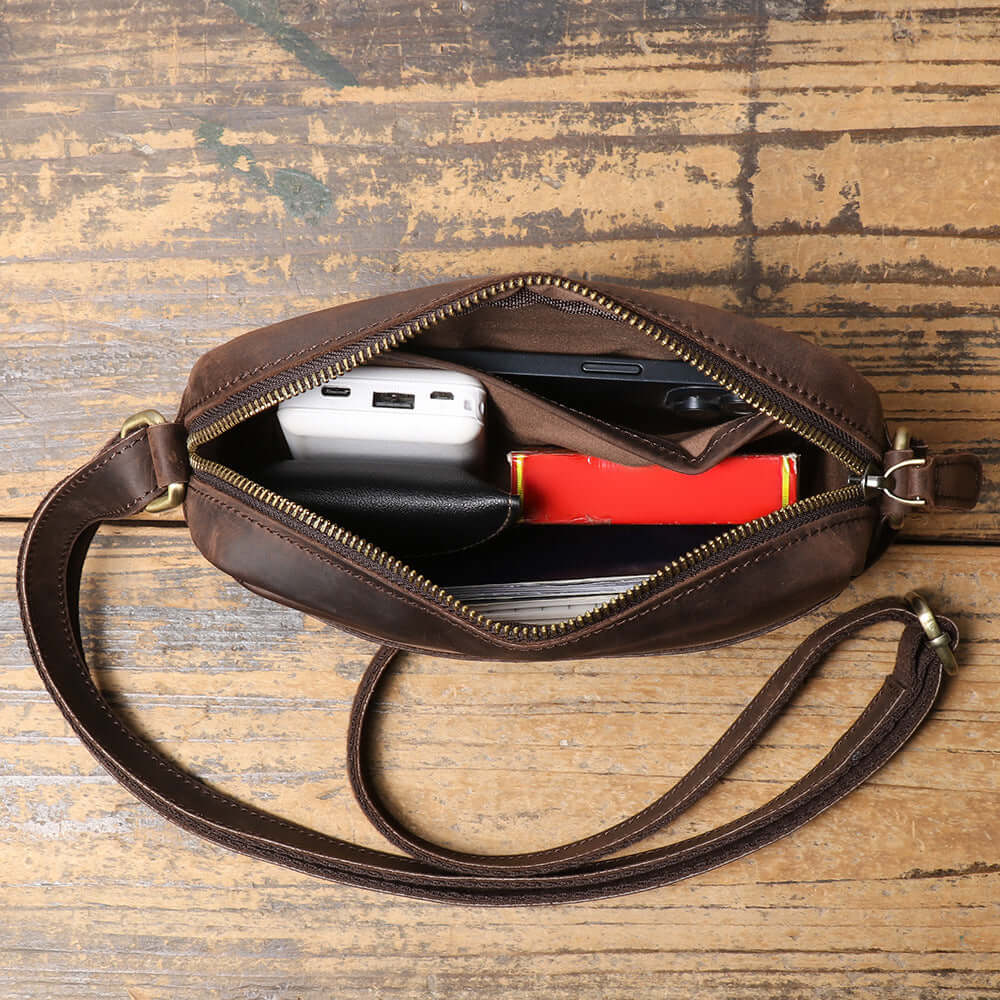 vintage leather crossbody bag with daily items inside