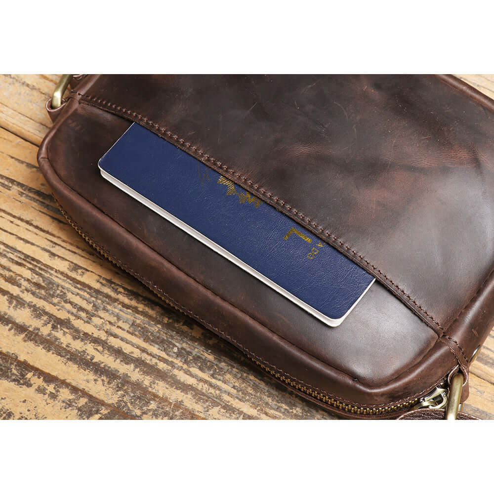 outer slot pocket holding a passport on leather crossbody bag