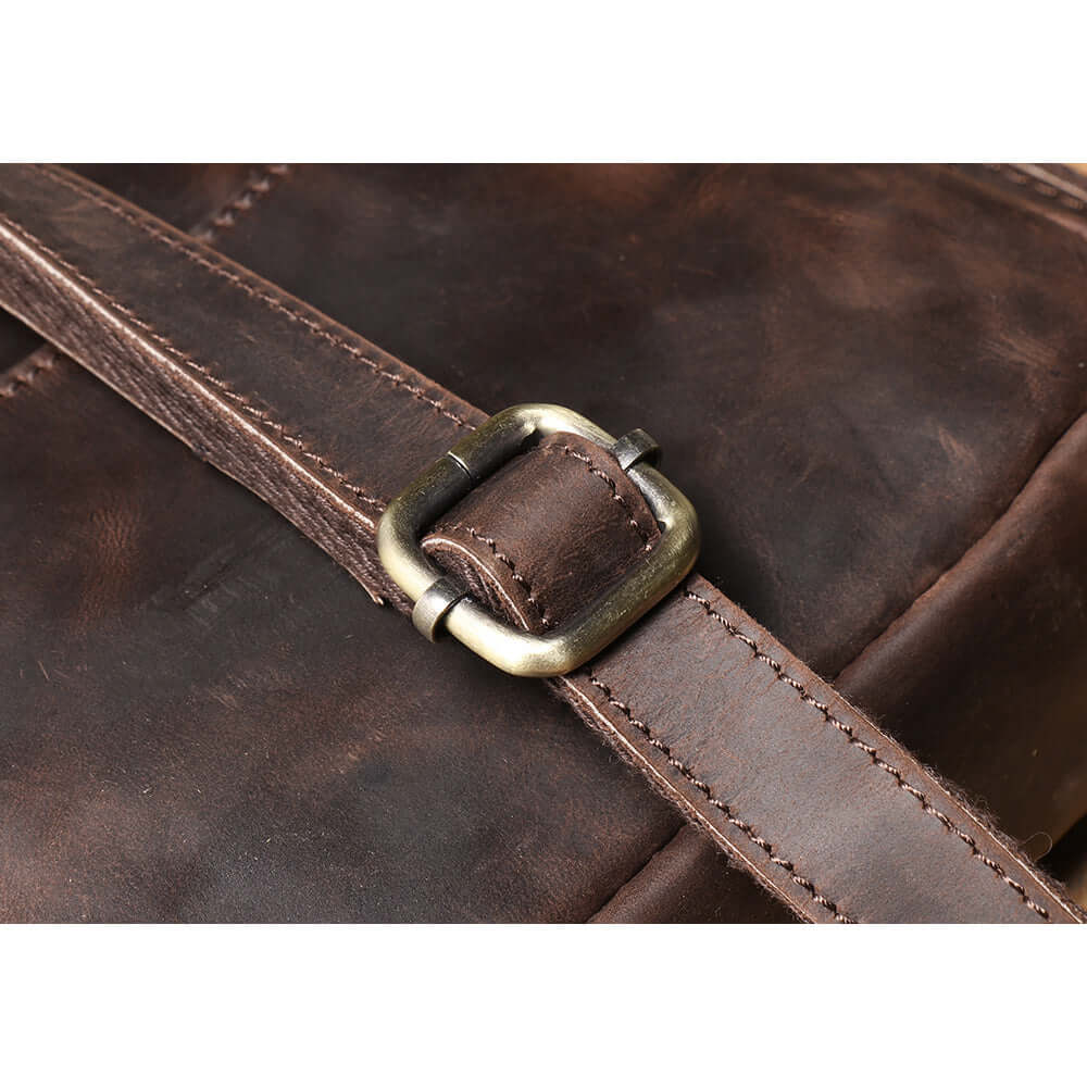 detailed view of shoulder strap on leather crossbody bag