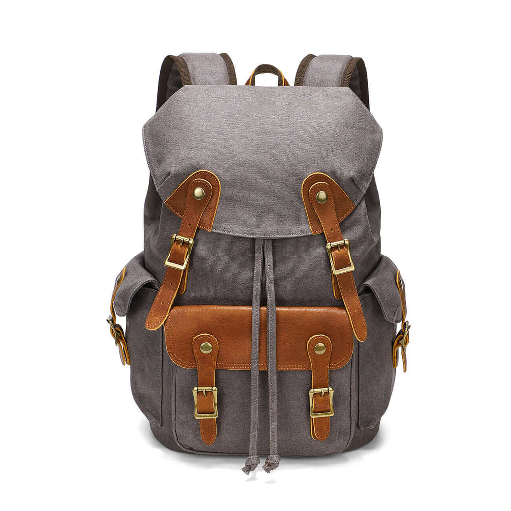 Front view of a vintage motorcycle-style canvas backpack with leather accents.