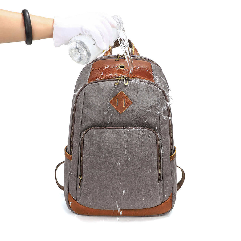 Waterproof waxed canvas backpack with genuine leather details.