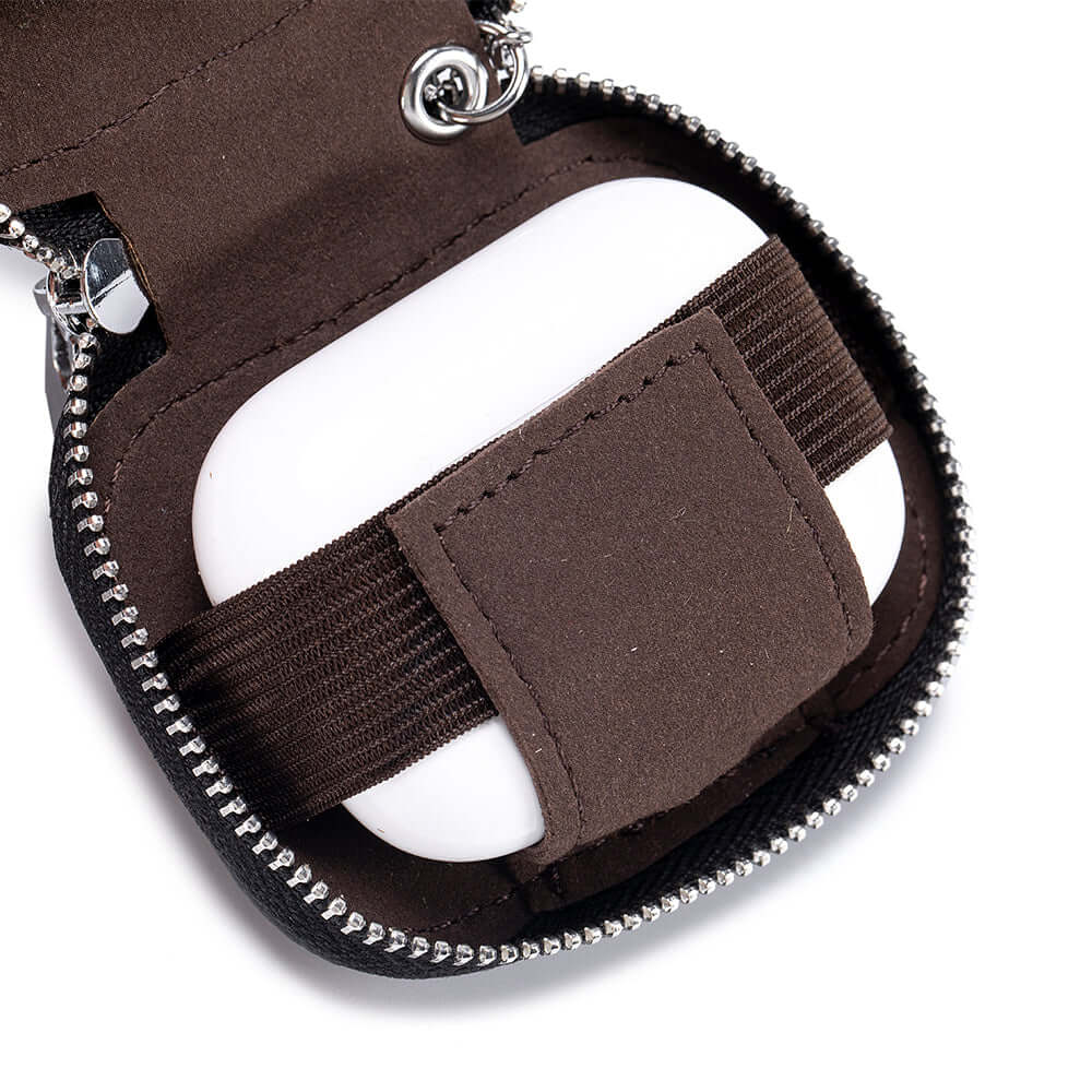 Interior of leather earphone pouch with elastic bands and lining.