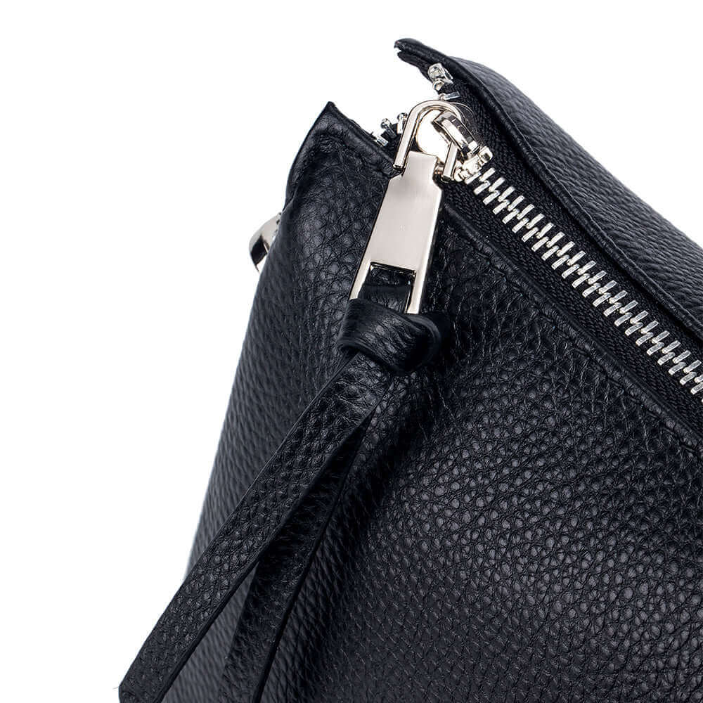 Detailed display of women's black genuine leather handbag.