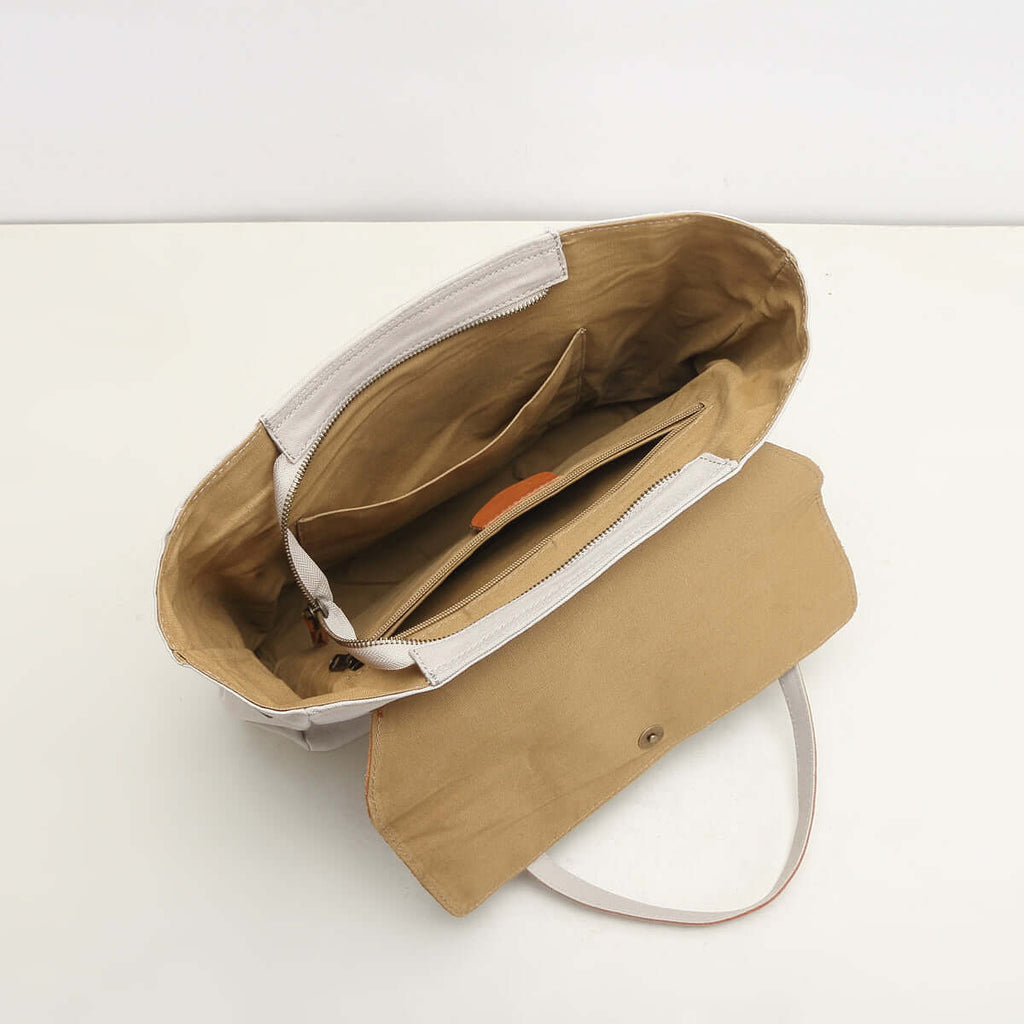 Interior compartments and zip pocket of canvas tote bag.