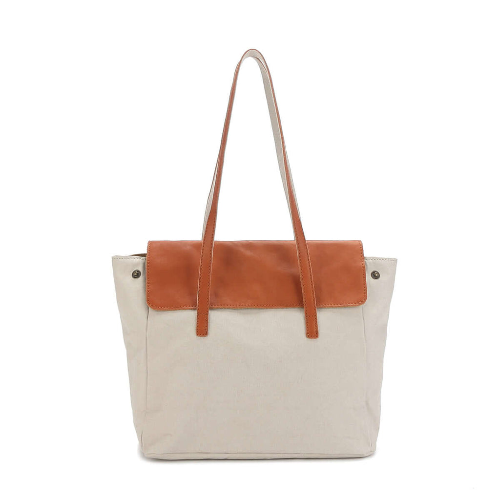 White canvas tote bag with tan leather flap and straps.