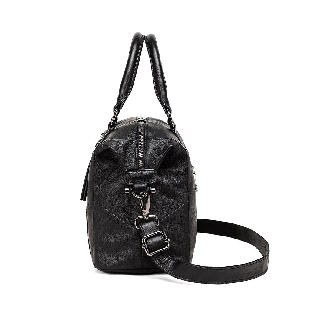 Angled view of black leather shoulder and crossbody handbag