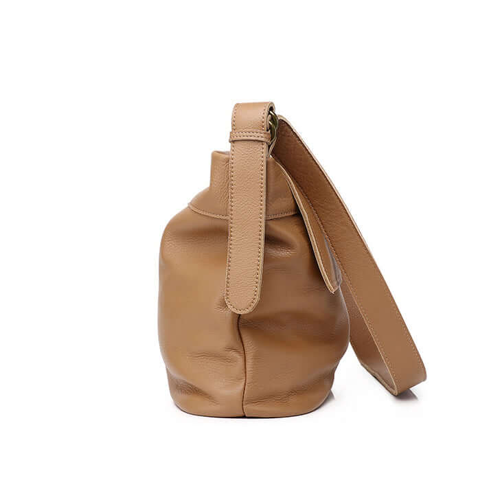 Side view of women's brown leather crossbody bag showing its spacious design.