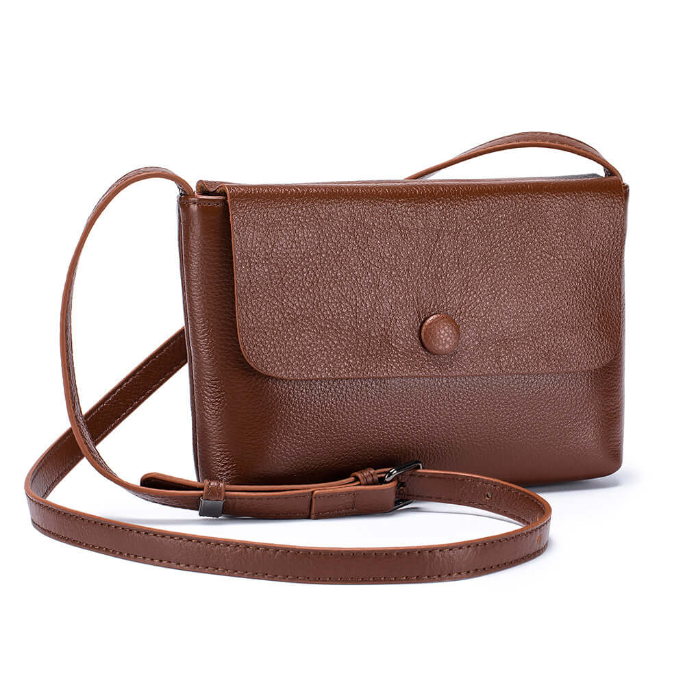 Adjustable shoulder strap of a women's brown leather crossbody bag.