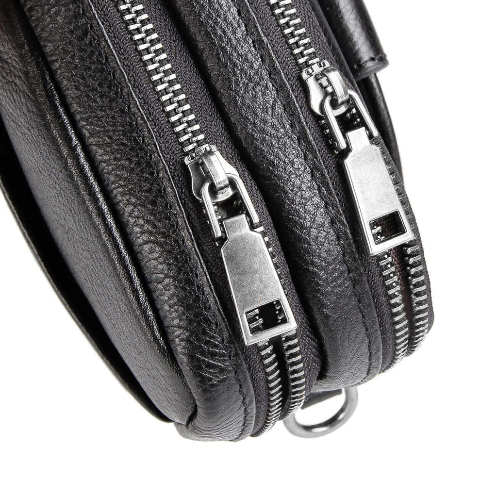 Black leather crossbody bag featuring dual-layered zippered compartments.