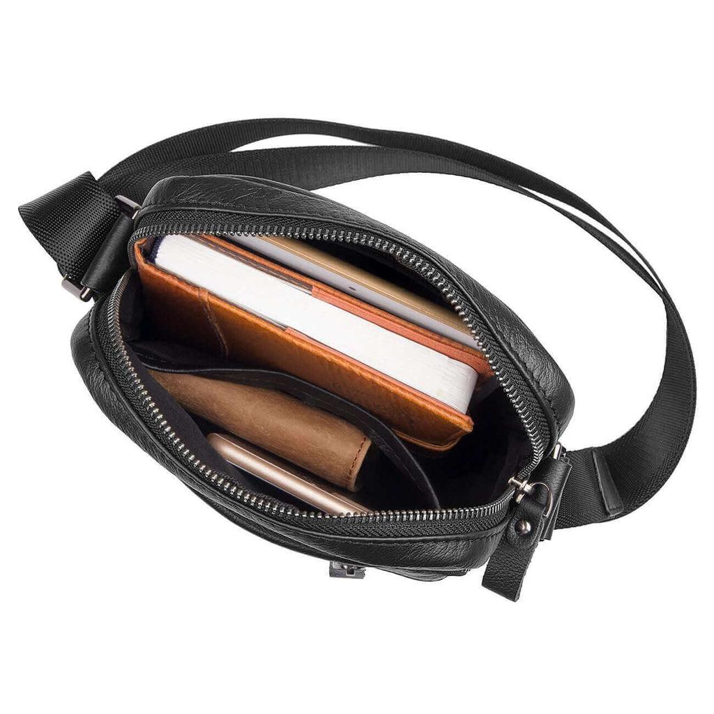 Open view of a men's black leather crossbody bag showcasing its compartments.