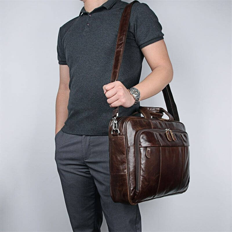 Brown leather laptop bag worn over the shoulder.