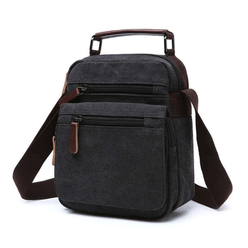 Black canvas crossbody bag designed for everyday use with multiple zippered compartments.