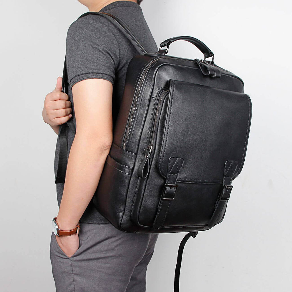 Genuine leather backpack fitting 14-inch laptops, perfect for men.