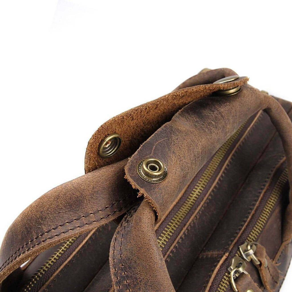 Detailed display of brown genuine leather briefcase laptop bag.