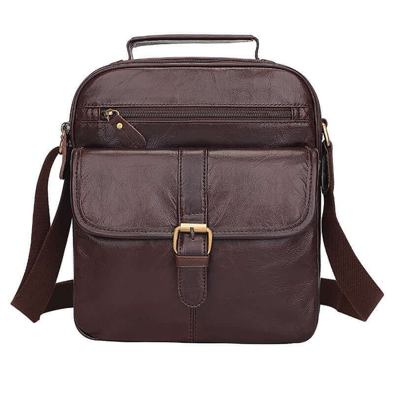 Front view of a coffee brown leather crossbody bag with zipper pockets.