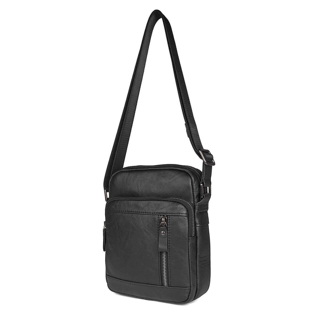 Adjustable strap on a men's black leather crossbody bag for versatile use.