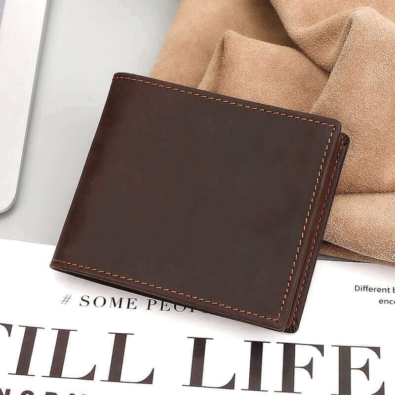 Flat lay of men’s vintage crazy horse leather wallet with accessories