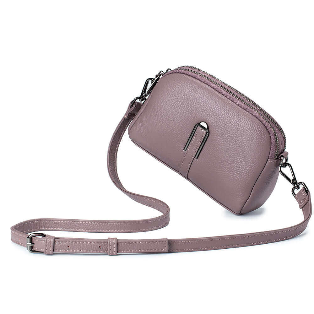 Purple leather crossbody bag featuring a double zipper design and ample storage.