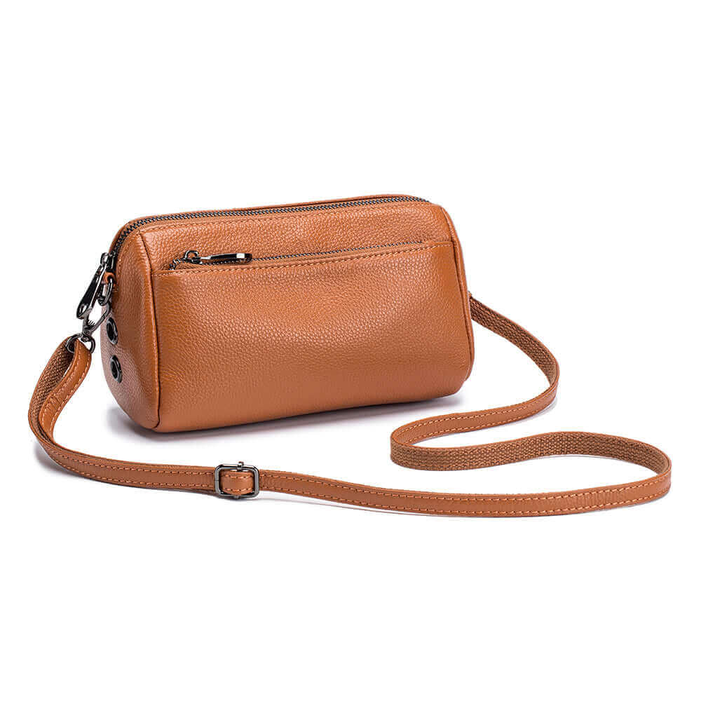 Sleek genuine leather crossbody bag in brown with adjustable strap and zipper pocket.