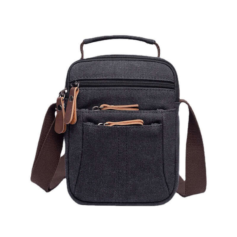 Small black canvas side bag with leather accents, perfect for casual outings.