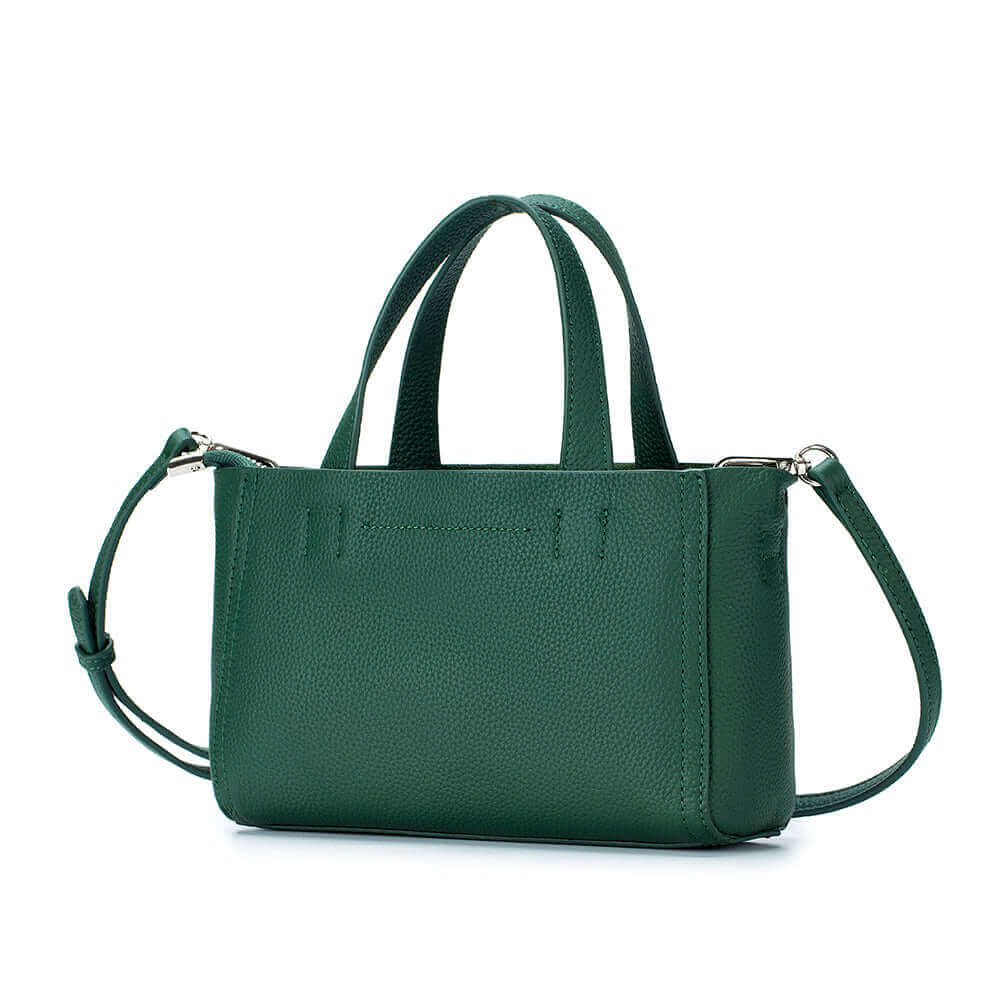 Small leather handbag with multifunctional design for handheld, shoulder, or crossbody wear.