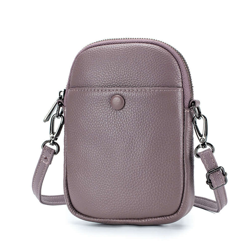 Small leather phone crossbody bag for women with decorative buckle and adjustable strap.